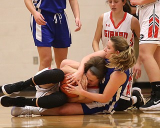 Hubbard's Ruthie Sandberg (3) and Girard's Sophie Griffith (5) fight for the ball in the second quarter of an AAC high school basketball game, Monday, Dec. 11, 2017, in Girard. Girard won 39-23...(Nikos Frazier | The Vindicator)