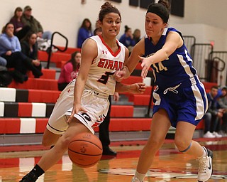Girard's Samantha Cave (3) dribbles towards the basket as Hubbard's Megan Learn (14) attempts to steal the ball in the second quarter of an AAC high school basketball game, Monday, Dec. 11, 2017, in Girard. Girard won 39-23...(Nikos Frazier | The Vindicator)