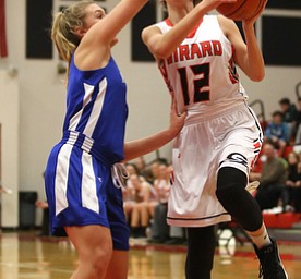 Girard's Emily Fitzgerald (12) goes up for a layup against Hubbard's Hannah Kist (4) in the second quarter of an AAC high school basketball game, Monday, Dec. 11, 2017, in Girard. Girard won 39-23...(Nikos Frazier | The Vindicator)