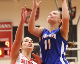 Hubbard's Jackie Adler (11) goes up for a layup against Girard's Olivia Ciminero (13) in the third quarter of an AAC high school basketball game, Monday, Dec. 11, 2017, in Girard. Girard won 39-23...(Nikos Frazier | The Vindicator)