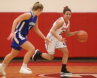 Girard's Samantha Cave (3) dribbles towards the basket against Hubbard's Hannah Kist (4) in the third quarter of an AAC high school basketball game, Monday, Dec. 11, 2017, in Girard. Girard won 39-23...(Nikos Frazier | The Vindicator)