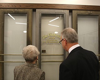 Mrs. Jagnow and Mark Brown look at the old Vindicator doors at the grand opening of the new Youngstown Business Incubator building, Monday, Dec. 11, 2017, in Youngstown...(Nikos Frazier | The Vindicator)