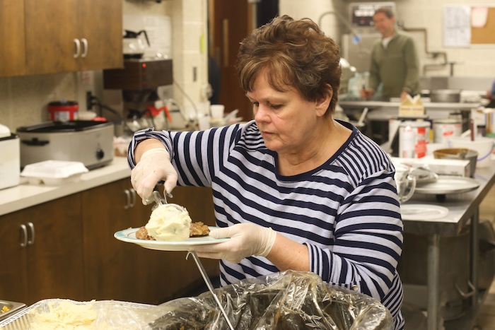 Karen Himes scoops out mashed potatoes during a recent Swiss steak dinner at Western Reserve United Methodist Church in Canfield. Visit vindy.com to see video about the event.