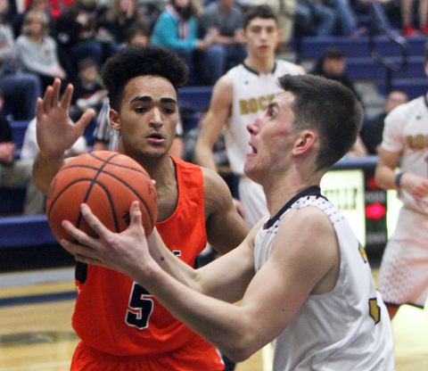 William D. Lewis The Vindictor  Lowellville's Dylan Durkin(34)) goes for 2 past Ridge's Jarred Miller(5) during 12-12-17 action at Lowellville.