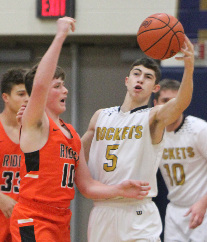 William D. Lewis The Vindictor  Lowellville's Alex Mamula-Zarlingo(5) stops a pass from Ridge's Kody Zupko(10) during 12-12-17 action at Lowellville.