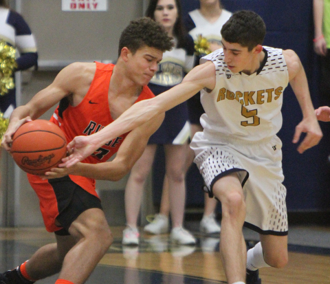 William D. Lewis The Vindictor  Lowellville's Alex Mamula-Zarlingo (5) tries to take the ball from Ridge'sTriston Weiss(33) during 12-12-17 action at Lowellville.