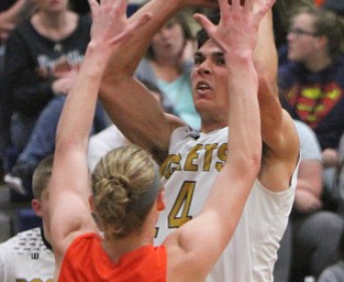 William D. Lewis The Vindictor  Lowellville's Joe Ballone(24) ) shoots over Ridge'sT Jordan Zupko(23) during 12-12-17 action at Lowellville.