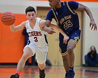 HOWLAND, OHIO - DECEMBER 12, 2017: Howland's Frank Rappach drives on East's Shannon Dubose during the first half of their game, Tuesday night at Howland High School. DAVID DERMER | THE VINDICATOR
