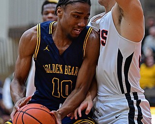HOWLAND, OHIO - DECEMBER 12, 2017: East's Kemon'Dre Muhammad drives on Howland's Howland's Kevin Moamis during the first half of their game, Tuesday night at Howland High School. DAVID DERMER | THE VINDICATOR