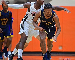 HOWLAND, OHIO - DECEMBER 12, 2017: East's Kemon'Dre Muhammad dribbles away from Howland's Samari Dean during the first half of their game, Tuesday night at Howland High School. DAVID DERMER | THE VINDICATOR
