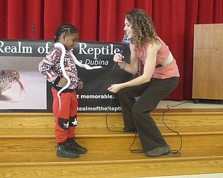 Neighbors | Zack Shively.The PTA likes to bring in speakers that will entertain the students while still having an educational program. Pictured, Marissa Dubina placed a Texas Rat Snake on a student's shoulders.
