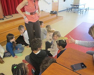 Neighbors | Zack Shively.During the large assembly, Marrisa Dubina took a small number of volunteers up to pet the animals she brought in. During the small assembly, she allowed each student to pet the animals. Pictured, Dubina placed the bearded dragon on a student's head.