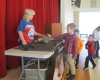 Neighbors | Zack Shively.Dubina and the PTA had the students form a line to pet Dubina's tortoise, bearded dragon and olive python at the end of the larger assembly.