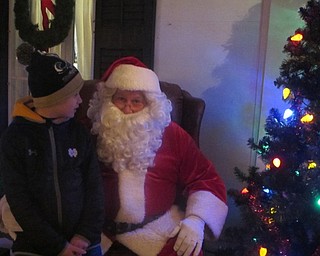 Neighbors | Zack Shively.Children could mail letters to Santa during the Lighting of the Village. Santa arrived via fire truck to the event, and children lined up to meet him. Pictured, Alex Miller sat on Santa's lap.