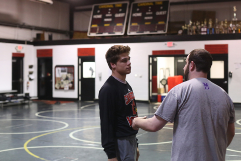 Anthony D'Alesio talks with coach Stephen Pitts during a regular season practice, Wednesday, Dec. 13, 2017, at Canfield High school in Canfield...(Nikos Frazier | The Vindicator)
