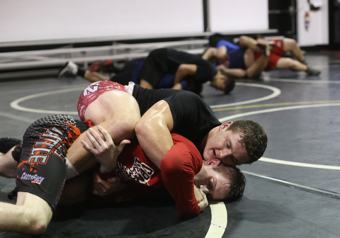 Tyler Stein works out with David Reinhart during a regular season practice, Wednesday, Dec. 13, 2017, at Canfield High school in Canfield...(Nikos Frazier | The Vindicator)
