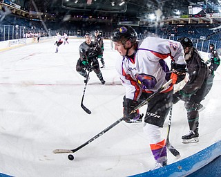 Scott R. Galvin | The Vindicator.Youngstown Phantoms center Mike Regush (21) skates the puck along the boards during the second period against the Cedar Rapids RoughRIders on Thursday, December 14, 2017 at the Covelli Centre.