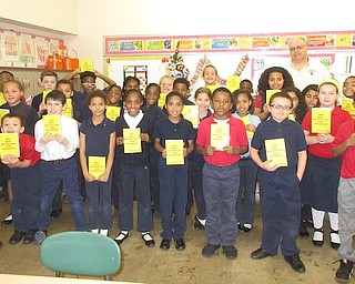 Struthers Rotary Club continued its dictionary project by recently delivering dictionaries to third-grade students at St. Nicholas and Struthers elementary schools. Above, are Rotarian Tom Baringer and the third-grade class at St. Nicholas School. Below, front, are Baringer; Ashley Marcucci, Da’Row Bussey, Zion Casey, Struthers Elementary School students; back, Bethany Carlson, Joan Jones, Struthers Elementary School principals; and Pete Pirone, Struthers superintendent and Rotarian.
