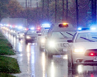 William D. Lewis The Vindicator Police escort/motorcade escorting body of slain Girard PD office Justin Leo makes its way up Churchill Rd. in girard Monday afternoon. The body was being transported to Blackstoine Funeral home after an autopsy in Cuyahoga county.