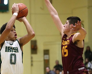 Ursuline forward Devan Keevey (0) goes up for two against South Range guard Mike Cunningham (15) in the first quarter of a high school basketball game, Friday, Dec. 15, 2017, in Youngstown. South Range won 61-38...(Nikos Frazier | The Vindicator)