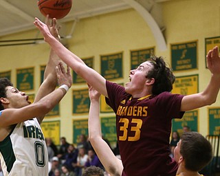 Ursuline forward Devan Keevey (0) goes up for two as South Range center Brady White (33) attempts to block the shot in the second quarter of a high school basketball game, Friday, Dec. 15, 2017, in Youngstown. South Range won 61-38...(Nikos Frazier | The Vindicator)