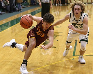South Range guard Jaxon Anderson (23) looses his footing while driving against Ursuline guard Vincent Armeni (22) in the third quarter of a high school basketball game, Friday, Dec. 15, 2017, in Youngstown. South Range won 61-38...(Nikos Frazier | The Vindicator)