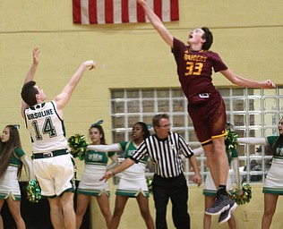 South Range center Brady White (33) attempts to block Ursuline forward Sean Phillips (14)s shot in the third quarter of a high school basketball game, Friday, Dec. 15, 2017, in Youngstown. South Range won 61-38...(Nikos Frazier | The Vindicator)