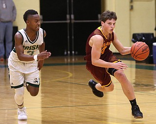 South Range guard Brennan Toy (4) dribbles as Ursuline point guard Braijon Nuby (3) attempts to block him out in the fourth quarter of a high school basketball game, Friday, Dec. 15, 2017, in Youngstown. South Range won 61-38...(Nikos Frazier | The Vindicator)