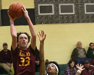 South Range center Brady White (33) goes up for two as Ursuline guard Daysean Harris (1) attempts to block his shot in the fourth quarter of a high school basketball game, Friday, Dec. 15, 2017, in Youngstown. South Range won 61-38...(Nikos Frazier | The Vindicator)