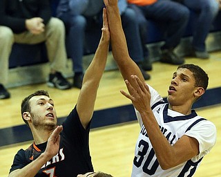 MCDONALD, OHIO - DECEMBER 15, 2017: McDonald's Braedon Poole (30) shoots as Springfield's Brandon Walters (3) and Springfield's Shane Eynon (12)  defend during the 1st qtr at McDonald High School.  MICHAEL G. TAYLOR | THE VINDICATOR
