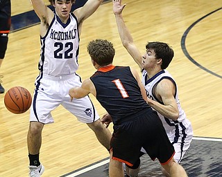 MCDONALD, OHIO - DECEMBER 15, 2017: McDonald's Ryan Scala (22) and McDonald's Josh Celli (10) pressure Springfield's Evan Ohlin (1) during the 1st qtr at McDonald High School.  MICHAEL G. TAYLOR | THE VINDICATOR