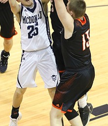 MCDONALD, OHIO - DECEMBER 15, 2017: McDonald's Zach Rasile (25) drives to the hopp as Springfield's Brandon Walters (3) and Springfield's John Ritter (13)  defend during the 1st qtr at McDonald High School.  MICHAEL G. TAYLOR | THE VINDICATOR
