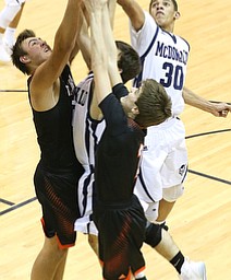 MCDONALD, OHIO - DECEMBER 15, 2017: McDonald's Braedon Poole (30) skies above the rest to grab the rebound during the 1st qtr at McDonald High School.  MICHAEL G. TAYLOR | THE VINDICATOR