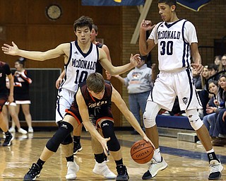MCDONALD, OHIO - DECEMBER 15, 2017: McDonald's John Celli (10) and McDonald's Braedon Poole (30) pressure Springfield's Clay Medurl (5) during the 4th qtr at McDonald High School.  MICHAEL G. TAYLOR | THE VINDICATOR