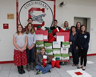 Members of Columbiana High School’s Interact Club and middle school student council members collected items to send to veterans deployed overseas through a program with Boatsie’s Boxes. More than 100 stockings were stuffed and boxed for delivery to West Virginia for a flight overseas. Students participating are, seated, Joey Baylor, and standing, front row: Elizabeth Siembida, Lily Marsco, Mrs. Stephanie Baylor and Logan Pasco. In back are Richard Ulam, Noah Silver, Marisa McDonough and Mrs. Meg Silver. Students presented the finished project during the Veteran’s Day program at the school.