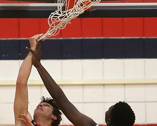 Canfield's forward Spencer Woolley (11) puts up a layup as Austintown Fitch forward AJ Green (13) attempts to block in the second quarter of an AAC high school basketball game, Saturday, Dec. 16, 2017, in Austintown. Canfield won 77-57...(Nikos Frazier | The Vindicator)