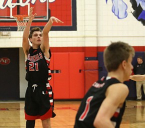 Canfield's guard Zach Tinkey (21) puts up three in the fourth quarter of an AAC high school basketball game, Saturday, Dec. 16, 2017, in Austintown. Canfield won 77-57...(Nikos Frazier | The Vindicator)
