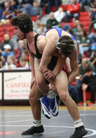 Canfield's McCoy Watkins(black) lifts up Reynold's Rocco Bartolo(blue) during a OSHAA 132 pound wrestling tournament, Saturday, Dec. 16, 2017, in Canfield. ..(Nikos Frazier | The Vindicator)