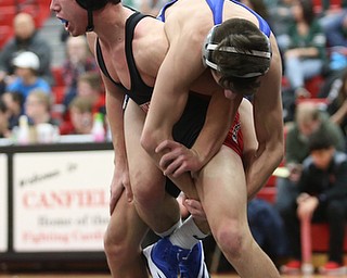 Canfield's McCoy Watkins(black) lifts up Reynold's Rocco Bartolo(blue) during a OSHAA 132 pound wrestling tournament, Saturday, Dec. 16, 2017, in Canfield. ..(Nikos Frazier | The Vindicator)