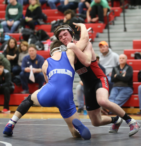 Canfield's Diovanni Dunlap(black) faces Reynold's Alex Ischo(blue) during a OSHAA 138 pound wrestling tournament, Saturday, Dec. 16, 2017, in Canfield. ..(Nikos Frazier | The Vindicator)