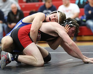 Reynold's Alex Ischo(blue) maintains his grip on Canfield's Diovanni Dunlap(black) during a OSHAA 138 pound wrestling tournament, Saturday, Dec. 16, 2017, in Canfield. ..(Nikos Frazier | The Vindicator)