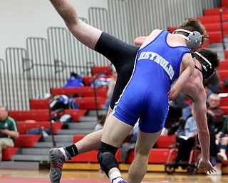 Reynold's Alex Ischo(blue) flips Canfield's Diovanni Dunlap(black) onto the mat during a OSHAA 138 pound wrestling tournament, Saturday, Dec. 16, 2017, in Canfield. ..(Nikos Frazier | The Vindicator)