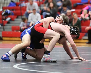 Reynold's Alex Ischo(blue) maintains his grip on Canfield's Diovanni Dunlap(black) during a OSHAA 138 pound wrestling tournament, Saturday, Dec. 16, 2017, in Canfield. ..(Nikos Frazier | The Vindicator)