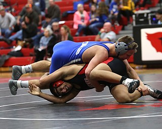 Canfield's Eric El-Hayek (black) struggles to escape Reynold's Cole Matthews(blue) during a OSHAA 145 pound wrestling tournament, Saturday, Dec. 16, 2017, in Canfield. ..(Nikos Frazier | The Vindicator)