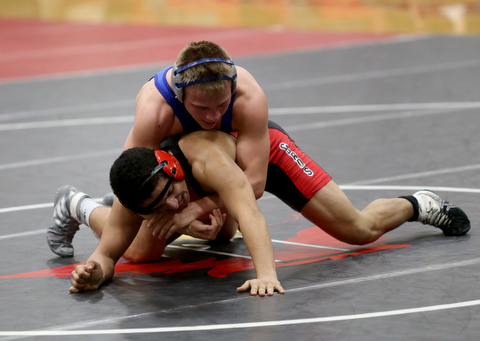 Canfield's Eric El-Hayek (black) struggles to escape Reynold's Cole Matthews(blue) during a OSHAA 145 pound wrestling tournament, Saturday, Dec. 16, 2017, in Canfield. ..(Nikos Frazier | The Vindicator)