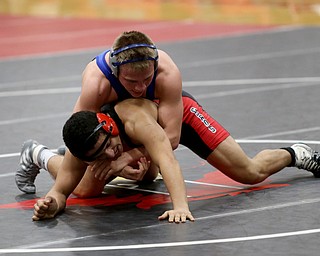 Canfield's Eric El-Hayek (black) struggles to escape Reynold's Cole Matthews(blue) during a OSHAA 145 pound wrestling tournament, Saturday, Dec. 16, 2017, in Canfield. ..(Nikos Frazier | The Vindicator)