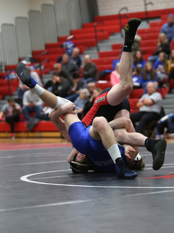 Canfield's David Reinhart(black) rolls over Reynold's Hunter Michaels(blue) during a OSHAA 152 pound wrestling tournament, Saturday, Dec. 16, 2017, in Canfield. ..(Nikos Frazier | The Vindicator)