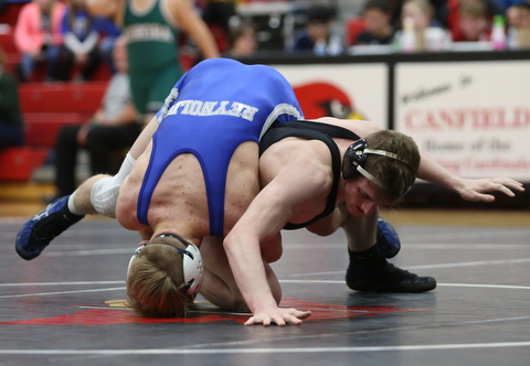 Canfield's David Reinhart(black) tries to escape Reynold's Hunter Michaels(blue) during a OSHAA 152 pound wrestling tournament, Saturday, Dec. 16, 2017, in Canfield. ..(Nikos Frazier | The Vindicator)