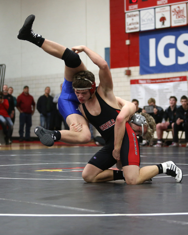 Canfield's Seth Hull(black) flips Reynold's Hunter Thompson(blue) during a OSHAA 160 pound wrestling tournament, Saturday, Dec. 16, 2017, in Canfield. ..(Nikos Frazier | The Vindicator)