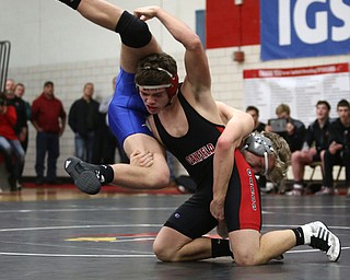Canfield's Seth Hull(black) flips Reynold's Hunter Thompson(blue) during a OSHAA 160 pound wrestling tournament, Saturday, Dec. 16, 2017, in Canfield. ..(Nikos Frazier | The Vindicator)